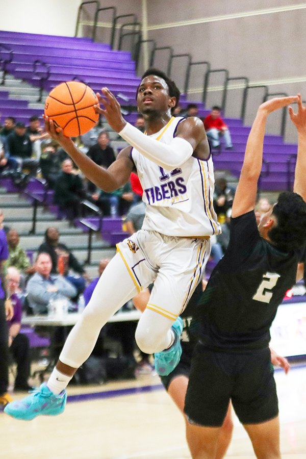 Lemoore's DeMel Turner goes high against Dinuba in Tigers' 60-52 win Wednesday night in the LHS Event Center.